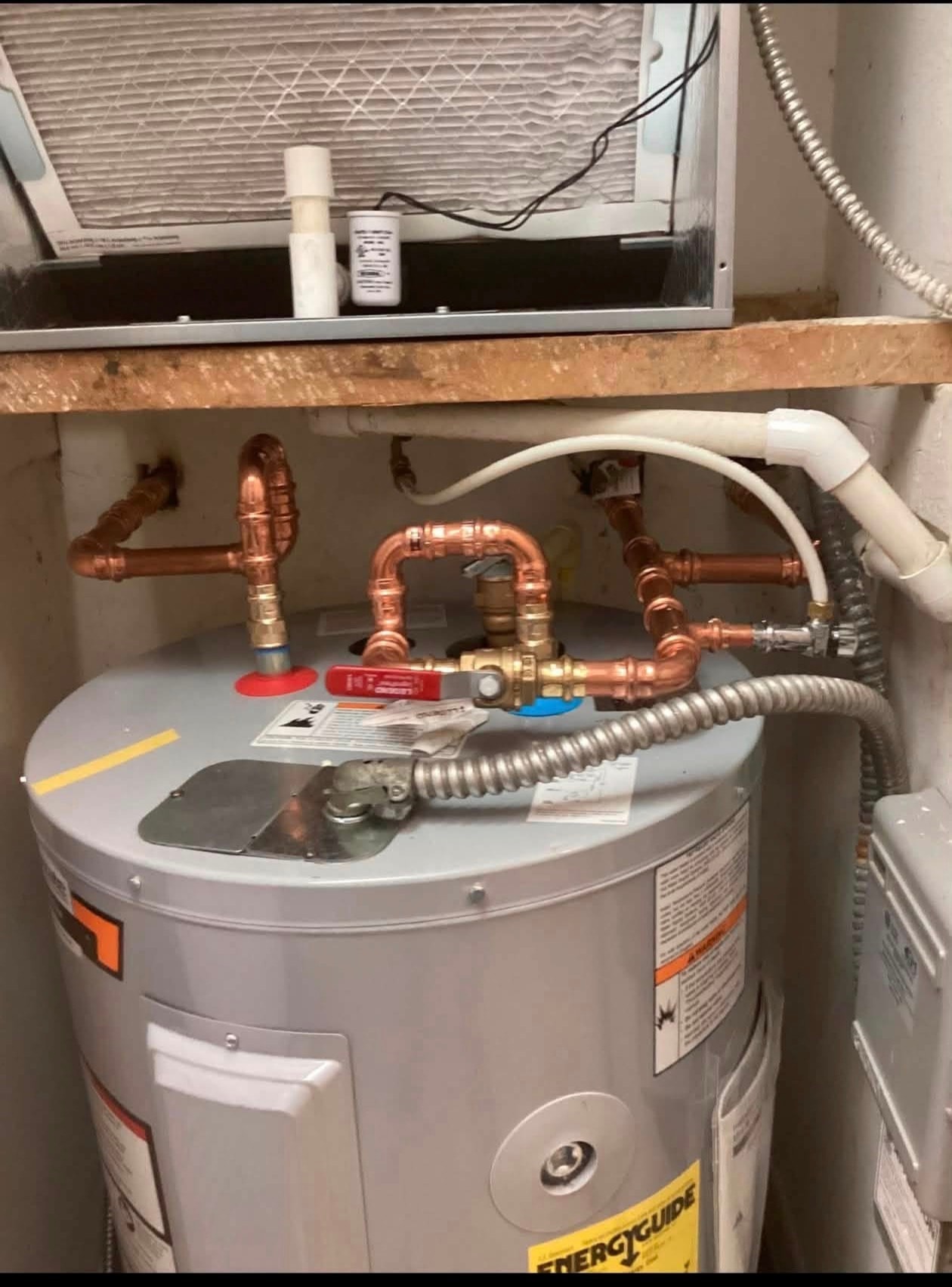 Electric water heater with copper pipe connections installed by MVP Plumber